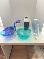 Overall lot view showing bowls, ladle, pitcher, carafe, dispenser