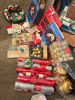 Lot overview showing wreath, window lights, ornaments, mesh rolls, craft items