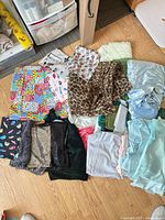 Overview of all assorted fabric pieces laid out on floor