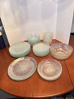 Full view of stacked dinner plates, salad plates, small bowls and large serving bowl