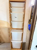 Full view of pine frame with five white bins stacked