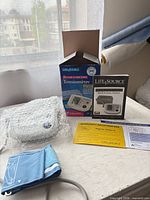 Monitor, cuff, AC adapter, box, manual on table
