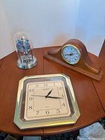 Overall view of three quartz clocks on table
