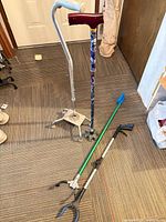 Group shot of two canes and two reachers on floor