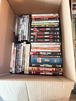 Open box showing Criminal Minds season sets and assorted DVDs