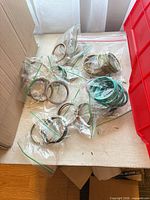 Loose zip bags each containing bangle sets spread on table