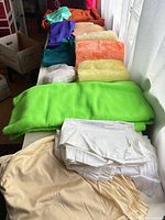 Folded neon green fleece, white satin, beige satin