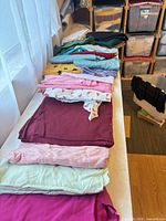 Stack of assorted solid color fabrics on table
