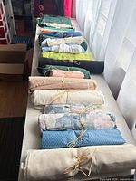 All fabric rolls lined on table showing quantity and variety