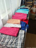 Row of folded fabric pieces showing various colors and textures