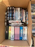 Open box showing multiple DVD spines and several boxed sets
