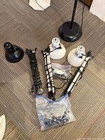 Disassembled lamp parts, bases, gooseneck arms, plastic shades, hardware bags