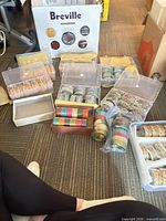 Overview of multiple plastic boxes containing assorted bangles