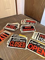 Multiple stacks of assorted P-T corrugated plastic signs spread on floor