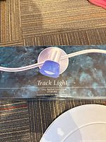 Box of brushed pewter track light showing product image and specifications