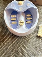 Top view of foot spa showing internal rollers and one disc attached