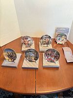 Six plates on boxes with stands displayed