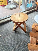 single stool opened showing seat and X-frame