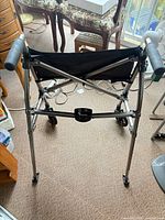 Front view of Stander aluminum rollator showing frame, seat, hand grips and wheels