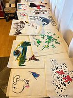 Table with multiple iron-on transfer sheets showing various animal and nature designs
