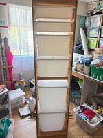 Full front view of wood frame with five white bins