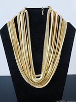 Necklace displayed on bust showing layered strands