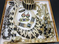 Overview of all twelve jewelry pieces arranged in tray