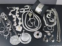 Group shot showing all 16 silver-tone jewellery pieces