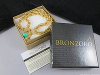 Necklace coiled in Bronzoro box showing clasp and box exterior