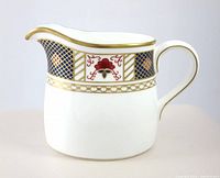 Profile view of cream pitcher showing pattern and shape