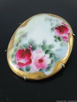 Front view showing full painted rose design and gilded border