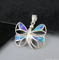 Front view of butterfly pendant showing opal inlay and silver detail