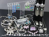 Full lot overview showing earrings on stand, bracelets, brooches and necklaces