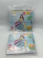 Two sealed Intex jumbo beach ball packages showing branding and size