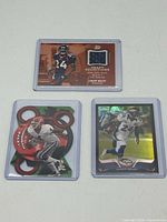Front view of three Champ Bailey cards in sleeves