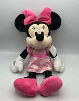 Front view of Minnie Mouse plush showing bow, dress and tag