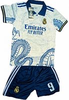 Front view of jersey and shorts set showing sponsor, crest, dragon graphic, tags attached