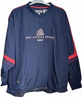 Front view of windbreaker showing embroidery, color, pockets and overall condition