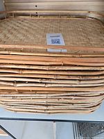 Stack of rattan trays showing edges and weave