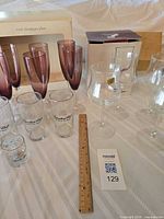 Group view of all glassware pieces with ruler for scale and boxes visible