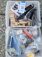 overview of two bins with hardware, tools, wooden biscuits, felt pads