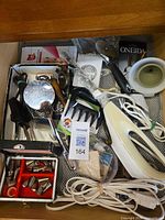 Drawer with assorted utensils and hand mixer
