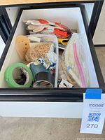 Drawer showing entire assortment of gloves, tapes, ties and organizer