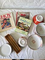 Overview showing books, four bowls, one plate, chopstick basket