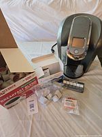 Keurig brewer, K-Cup box, filters, reusable pods, cleaning kit overview