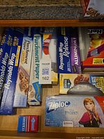 Drawer view showing foil, parchment paper, Ziploc Frozen box, Homebase bags, Diamond toothpicks