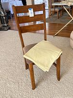 Front three-quarter view of chair with tablecloth on seat