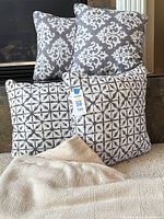 Group image of four pillows and knit throw blanket