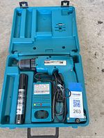 Makita cordless drill, battery, charger and case displayed open
