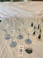 Group of four blue-stem martini glasses, four margarita glasses and six champagne flutes on table